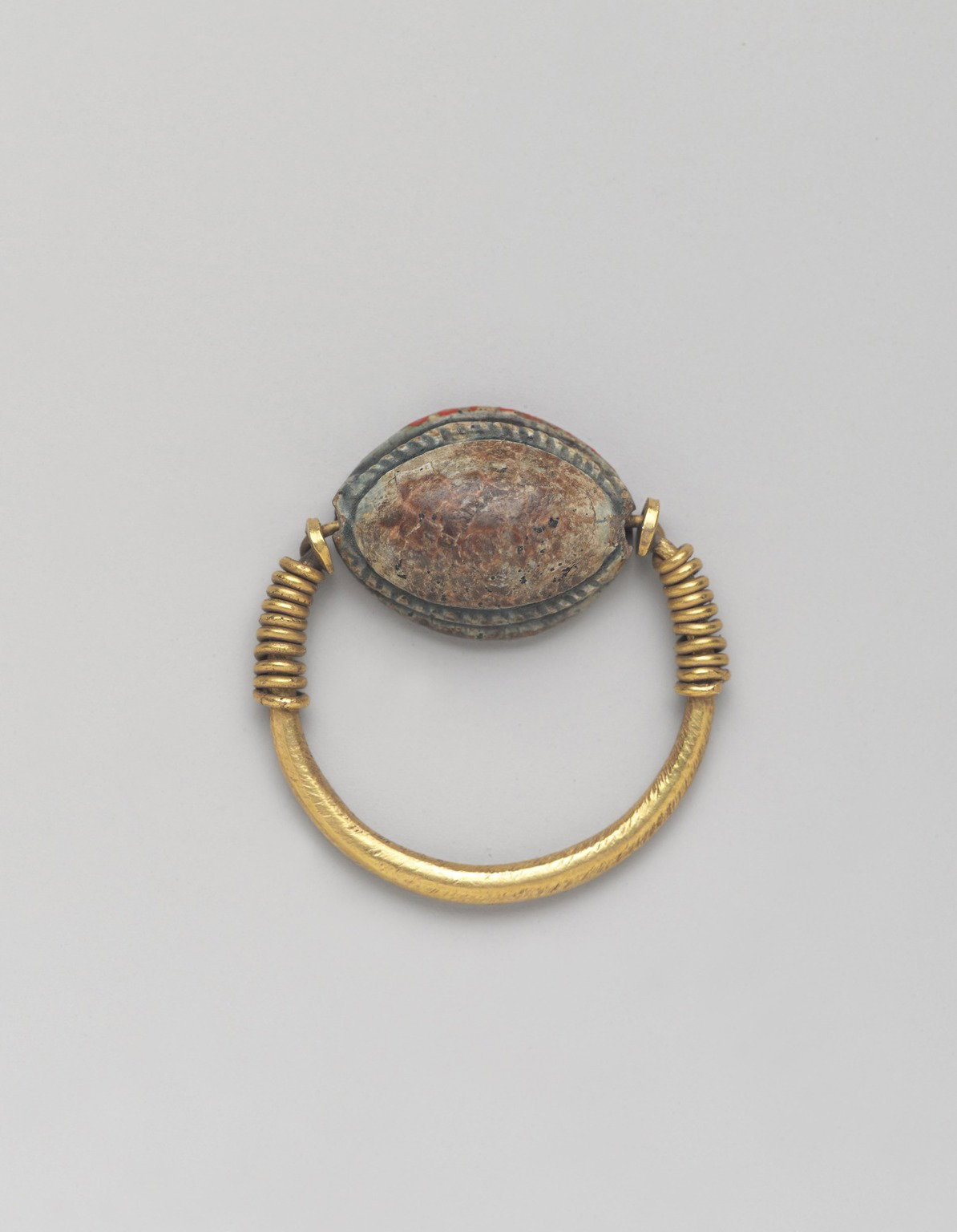 Cowrie-Shaped Amulet in Gold Ring