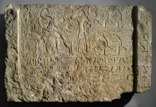 Relief of Khamwasemen and His Wife Seated at the Table of Offerings with Standing Priest